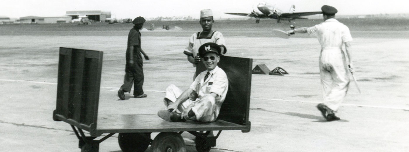 Pilot sitting on airfield trolley