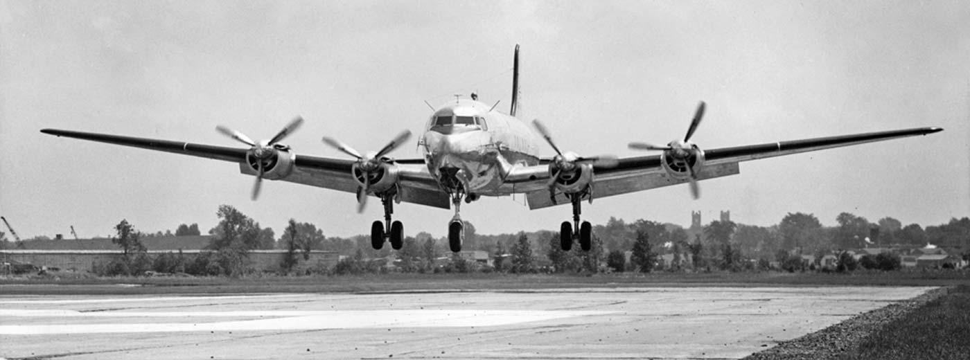 Four engine prop aircraft flaps down about to land